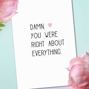 Puede incluir: Una tarjeta blanca con texto negro que dice "DAMN. YOU WERE RIGHT ABOUT EVERYTHING." con un coraz&oacute;n rosa.