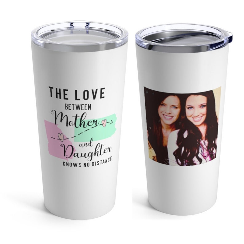 May include: White stainless steel travel tumbler with a pink and green graphic that says "The love between mother and daughter knows no distance". A photo of two women is on the other side of the tumbler.