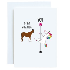May include: A greeting card with a white unicorn holding a pole with a pink star on top. The unicorn has a rainbow mane and tail. The text on the card reads "YOU" above the unicorn and "OTHER 60 YR OLDS" next to a brown horse.
