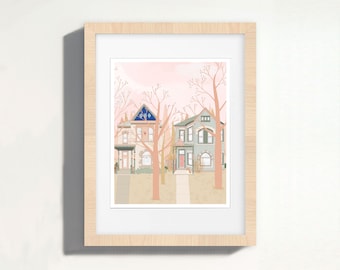 May include: A framed illustration of two houses with pink and blue accents, surrounded by trees with pink leaves. The houses are set against a pink sky.