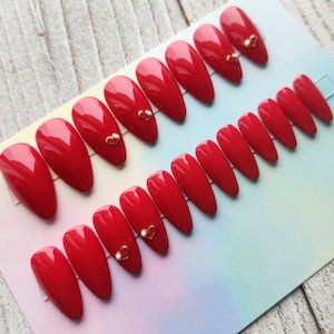 Classic Red Nails with Gold Heart and White Pearl accent. Handmade Reusable Press On Nails • Fake Nails • Nails with Gold Charm