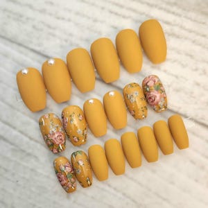 Floral designs over Mustard Yellow Press On Nails. Faux|False|Fake nails. Spring| Summer floral, yellow nails. White pearls.