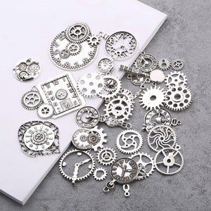 May include: A collection of silver-toned metal charms featuring clock faces and gears. The charms are perfect for jewelry making, scrapbooking, and other craft projects.