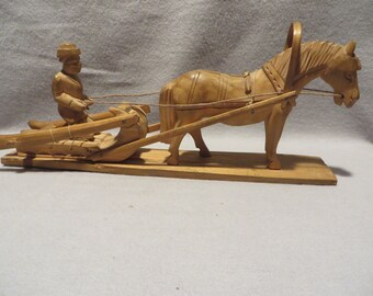 Vintage Hand Carved Horse Pulling a Sleigh and Its Driver