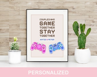 May include: A printable wall art design with the text "Couples who game together stay together" and the names "Katie & Peter". The design features two pixelated game controllers, one pink and one blue.