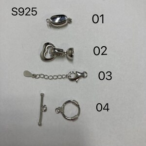 May include: Four different silver-toned jewelry clasps, labeled 01 through 04.  The clasps are for necklaces, bracelets, or other jewelry.