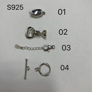 May include: Four different silver-toned jewelry clasps, labeled 01 through 04. The clasps are a heart-shaped toggle clasp, a lobster claw clasp, a toggle clasp, and a round ring clasp.