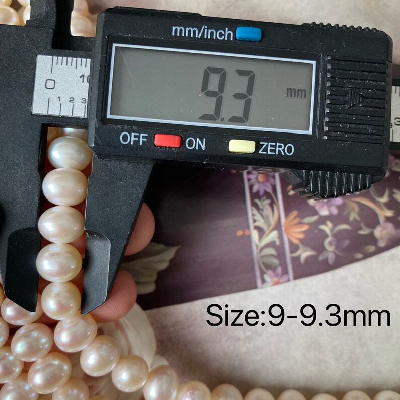 May include: A close-up of a pearl necklace measured with a caliper. The caliper reads 9.3 mm. The text "Size: 9-9.3mm" is visible below the necklace.