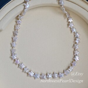 May include: A white pearl necklace with star-shaped beads. The necklace is displayed on a white background. @Etsy NorthwestPearlDesign