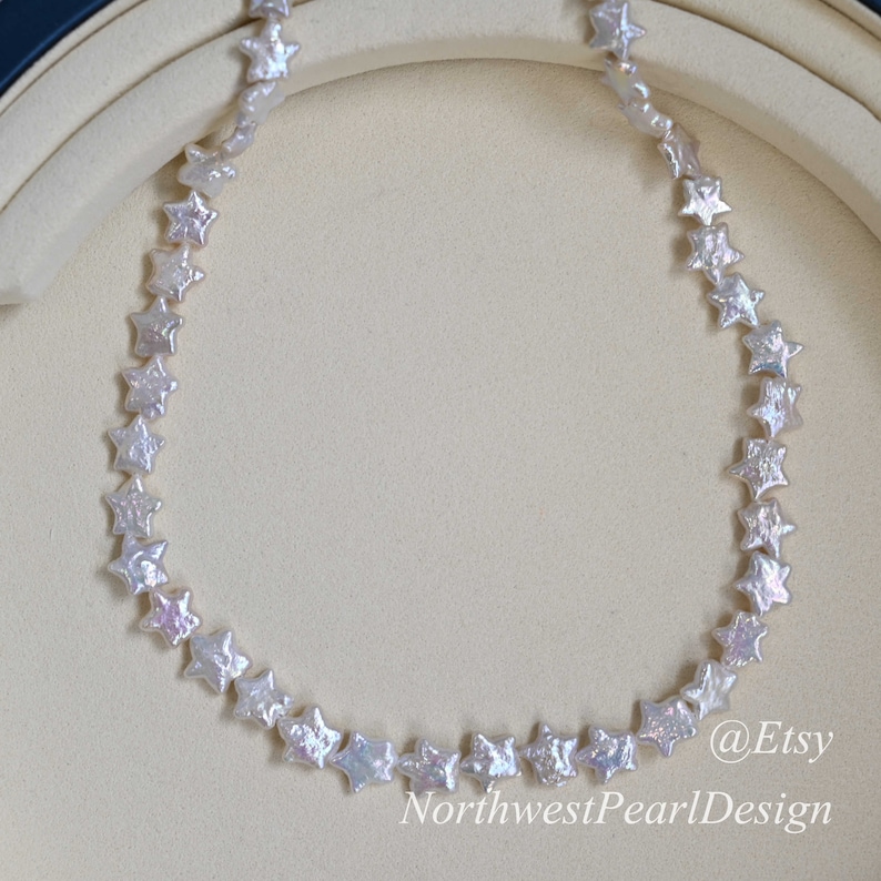 May include: A white pearl necklace with star-shaped beads. The necklace is displayed on a white background. @Etsy NorthwestPearlDesign
