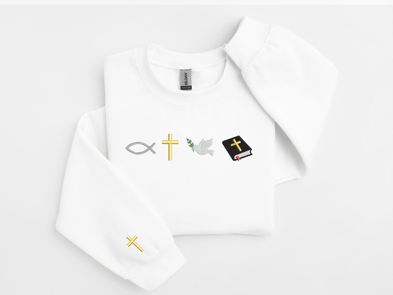 May include: White sweatshirt with a gold cross, a dove, a fish, a green olive branch, and a closed black book with a gold cross on the cover.
