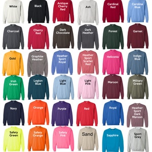May include: A chart of 36 different colored sweatshirts, each with a text label indicating the color. The colors include white, black, antique cherry red, ash, cardinal red, carolina blue, charcoal, cherry red, dark chocolate, dark heather, forest, garnet, gold, graphite heather, heather sport royal, heather sport scarlet red, heliconia, indigo blue, irish green, legion blue, light blue, light pink, maroon, military green, navy, orange, purple, red, royal, heather sport dark maroon, safety green, safety orange, safety pink, sand, sapphire, and sport grey.
