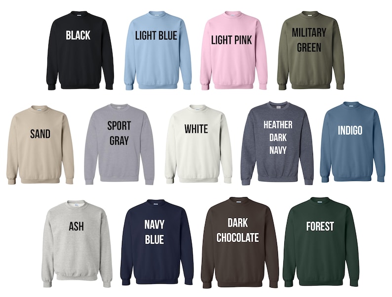 May include: A collection of crewneck sweatshirts in various colors, including black, light blue, light pink, military green, sand, sport gray, white, heather dark navy, indigo, ash, navy blue, dark chocolate, and forest. Each sweatshirt has the color name printed in white.