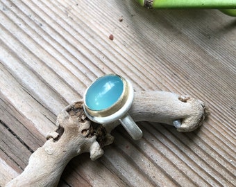 Silver ring with seablue chalcedony cabochon in 585 gold setting (14k)