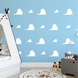 May include: A light blue wall with white cloud stickers. The wall is decorated with a variety of sizes and shapes of clouds. The clouds are arranged in a random pattern.