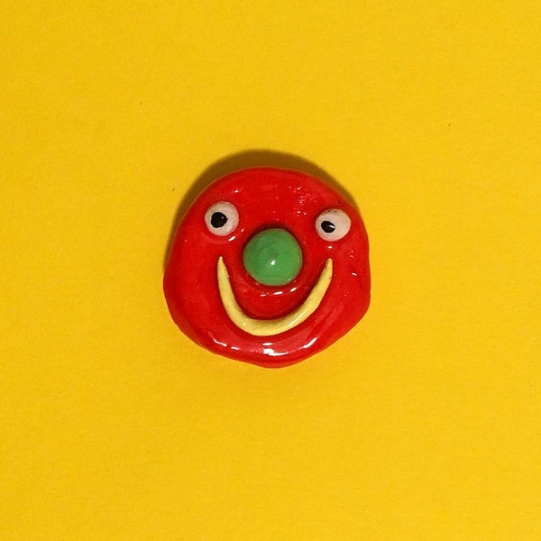 Clay face pin badge