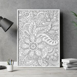 May include: A black and white printable coloring page featuring an intricate floral design with paisley patterns. The design is framed in a white frame and is ready to be colored.
