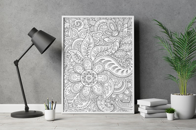 May include: A black and white printable coloring page featuring an intricate floral design with paisley patterns. The design is framed in a white frame and is ready to be colored.