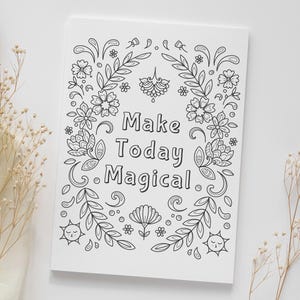 May include: A black and white printable coloring page with a floral border and the text "Make Today Magical".