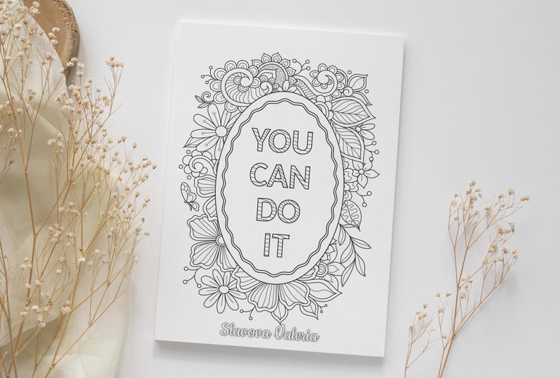 May include: Black and white coloring page featuring a decorative floral frame with the text "YOU CAN DO IT" inside. The artist's name, "Slavova Valeria", is printed at the bottom.