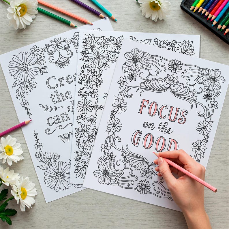 May include: Three black and white coloring pages with floral designs and inspirational quotes. The quotes are "Create the you can be", "Focus on the good", and "You are enough".