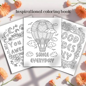 May include: Three inspirational coloring book pages with black and white line art. One page features a hot air balloon design with the words "SMILE EVERYDAY". Another page says "YOU AWES". The third page says "GOOD VIBES ONLY". Orange flowers surround the pages.