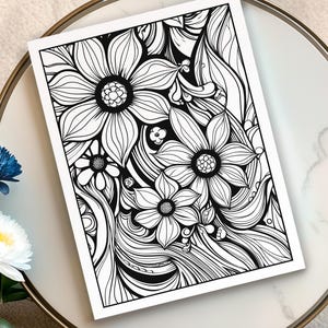 May include: Black and white floral line art print featuring detailed flower and leaf designs. The artwork is on a white paper, perfect for coloring or display. The image is set on a white and gold-rimmed surface.