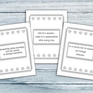 May include: Three white cards with black outlines and text. Each card has a decorative border with hearts and scalloped edges. The text on the cards reads: "Creativity takes courage, but the result is always beautiful.", "Life is a canvas&mdash;make it a masterpiece with every hue.", and "In a world full of chaos, art brings balance."