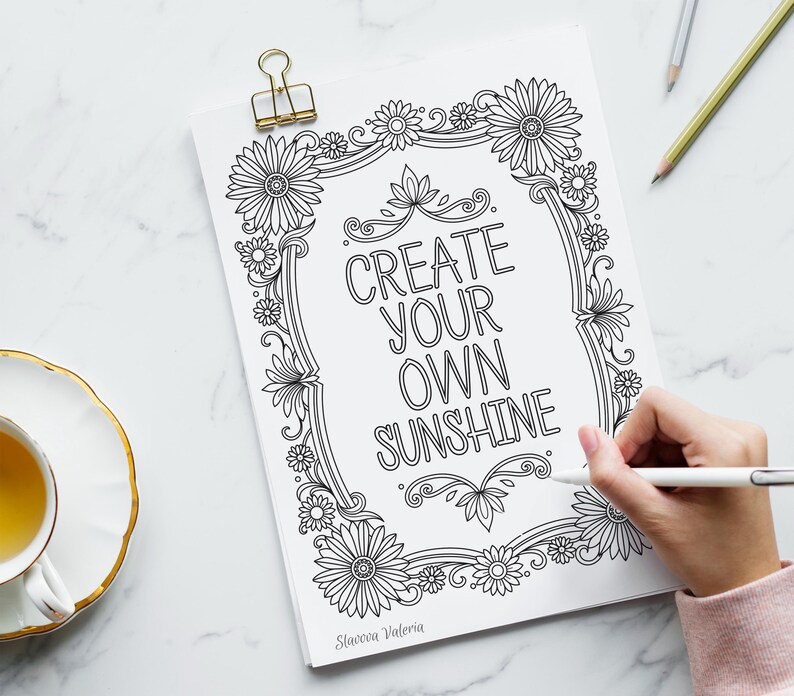 May include: Black and white printable coloring page featuring a floral frame with the text "Create your own sunshine".