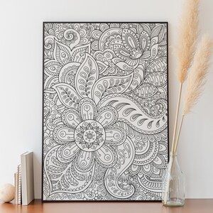 May include: Black and white framed print of an intricate floral design with paisley patterns. The design is detailed and complex, with many overlapping shapes and lines.
