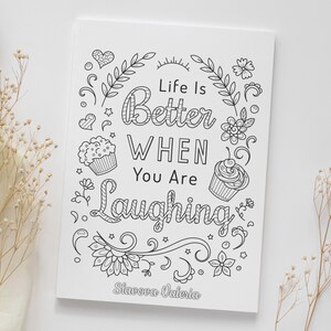 May include: Black and white printable coloring page with the text "Life is Better When You Are Laughing" surrounded by flowers, leaves, and cupcakes. The page is signed "Stavora Valeria".