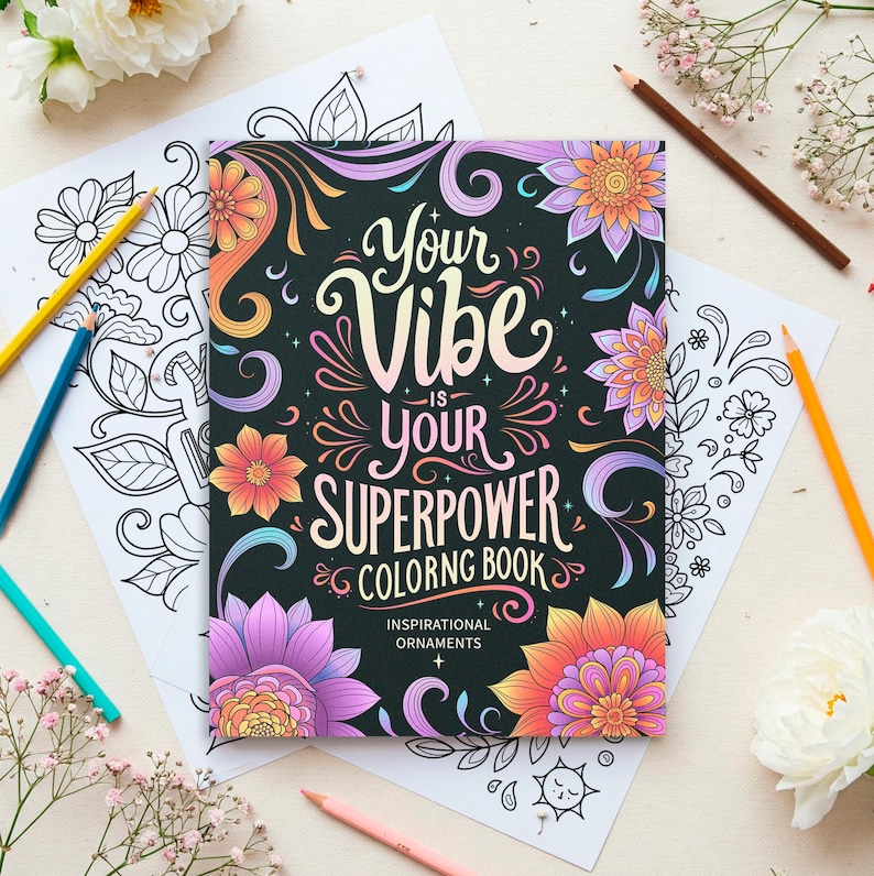 May include: A black coloring book with the text "Your Vibe Is Your Superpower Coloring Book" and colorful floral illustrations. The book has the words "Inspirational Ornaments" printed on the bottom.