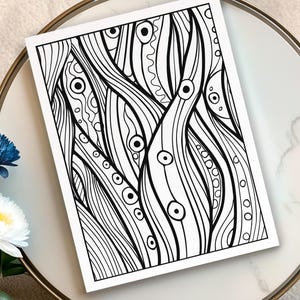 May include: Black and white abstract art print featuring a flowing, organic design with lines, circles, and various patterns. The artwork is displayed on a white background, creating a high-contrast visual effect. The print is placed on a white and gold decorative tray.