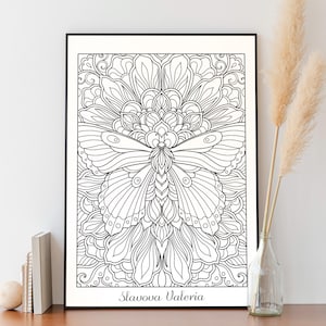 May include: Black and white line art print of a butterfly with intricate details. The butterfly is surrounded by a floral design. The print is framed and has the artist's name, Slavova Valeria, at the bottom.