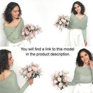 May include: A woman is wearing a sage green knitted shrug over a white skirt. She is holding a bouquet of pink roses. You will find a link to this model in the product description.