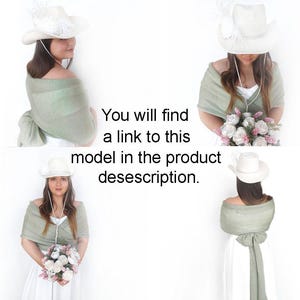 May include: Three women wearing white cowboy hats and sage green shawls. The shawls are tied around the neck and drape down the back. The women are wearing white dresses and holding bouquets of flowers.