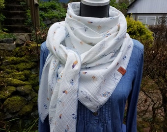 Beautiful triangular scarf made of white muslin with blue and orange branches and feathers