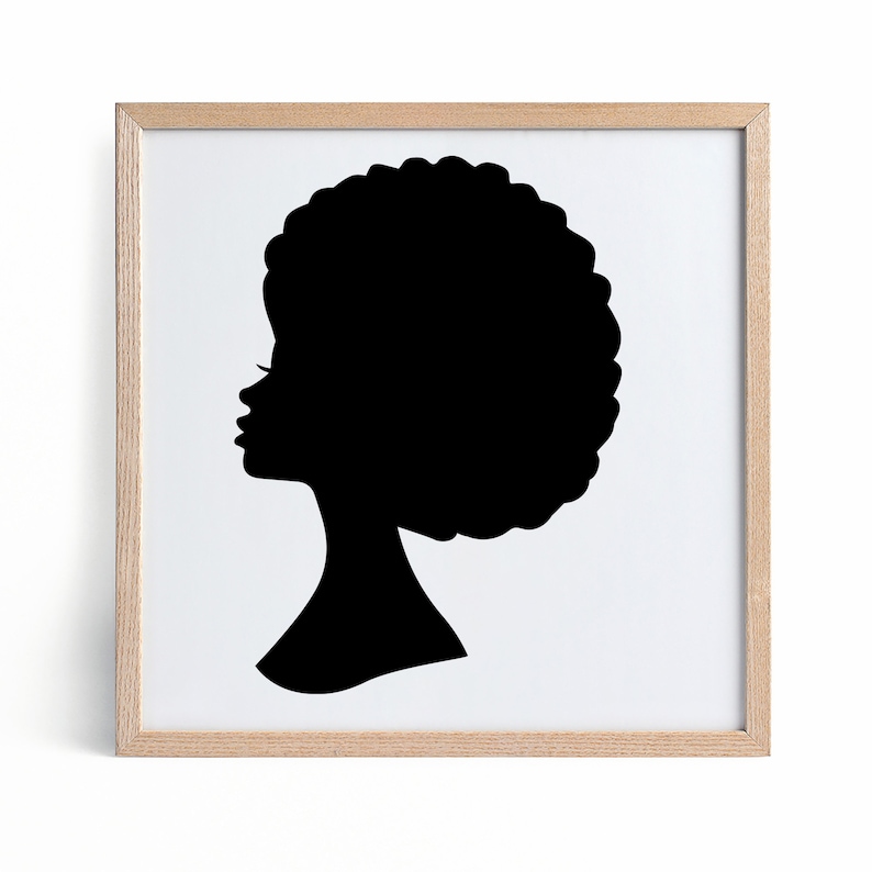 May include: A black silhouette of a person with an afro hairstyle in a light wood frame.