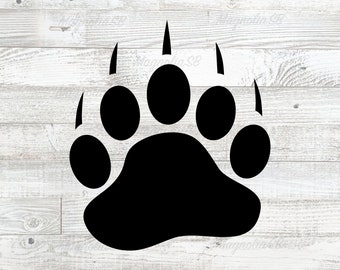 May include: Black bear paw print silhouette on a white wood background.