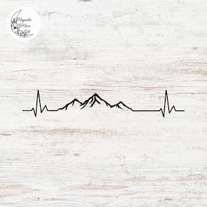 May include: Black line art of a mountain range with a heartbeat-like line. The design is on a white wooden background. A circular logo with the text "Magnolia Moon Art" and floral elements is in the upper left corner.