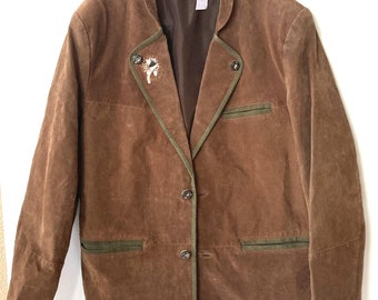 May include: A brown suede jacket with green trim and a button closure. The jacket has a small embroidered design on the left lapel.