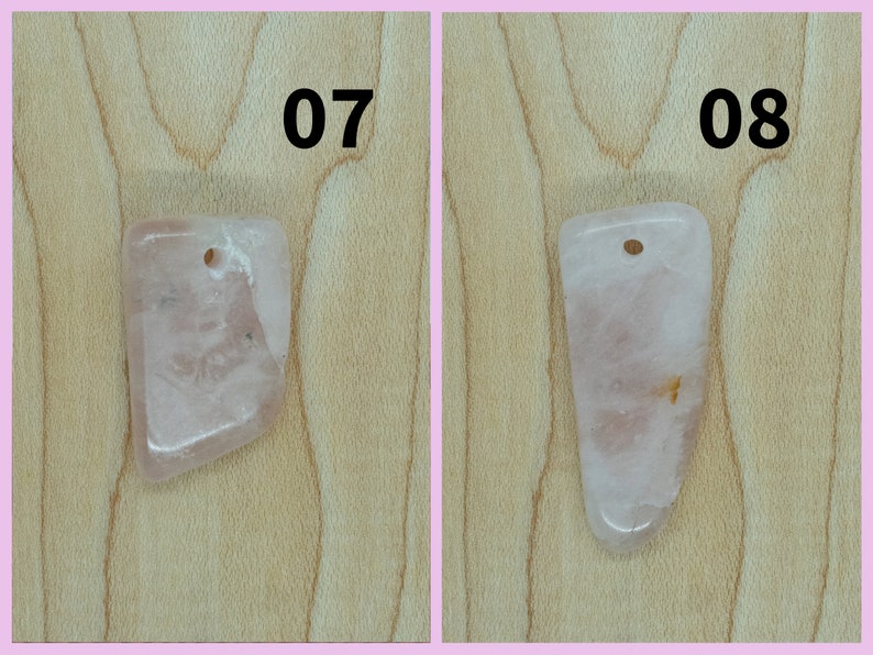 May include: Two pink rose quartz pendants with a hole drilled at the top for stringing. The pendants are on a light brown wooden surface. The numbers 07 and 08 are printed above the pendants.