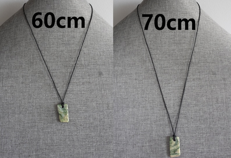 May include: Two necklaces with a green and white stone pendant. The necklace on the left is 60cm long and the necklace on the right is 70cm long.