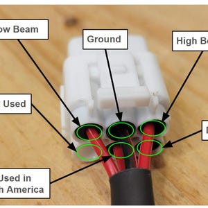 May include: A close-up of a white electrical connector with black and red wires. Text labels include "Low Beam", "Ground", "High Beam", and "DRL". The text "Not Used" and "Not Used in North America" are also visible.