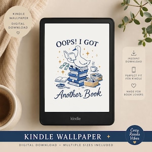 May include: A black Kindle e-reader displays a digital wallpaper with the text "OOPS! I GOT Another Book." The design features a cartoon duck reading on a stack of books, with money and a coffee cup. The words "Kindle Wallpaper" are at the bottom.