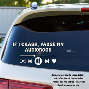 May include: White vinyl decal for a car window with the text "IF I CRASH, PAUSE MY AUDIOBOOK" above media control icons. The decal includes a skip backward, play/pause, skip forward, and heart symbol.