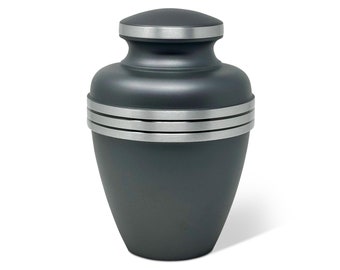 May include: A dark gray urn with a silver band around the middle and top. The urn has a rounded shape with a lid. The urn is designed to hold the cremated remains of a loved one.