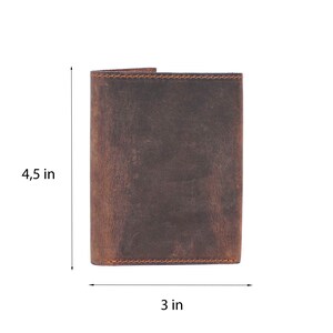 May include: A brown leather wallet with a distressed finish. It measures 4.5 inches tall and 3 inches wide.