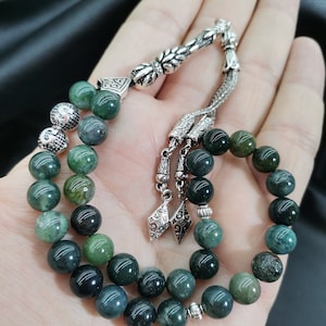 May include: A rustic wooden sign with the text "Welcome to our porch" in white lettering. The sign features a distressed finish and a simple, inviting design, perfect for outdoor decor.