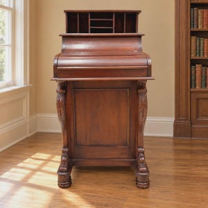 May include: A dark brown wooden roll-top desk featuring a curved sliding cover, a flat writing surface, and an upper hutch with multiple open storage compartments. The desk is supported by two carved vertical legs with detailed leaf motifs.